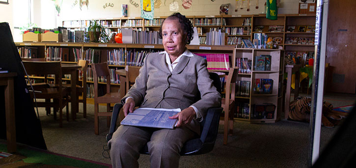 W.C. Taylor High School alum sharing her year book for a documentary on the school. Photo: Kauri George.